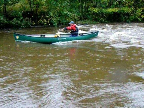 Open Canoe Surfing On River Endrick Scotland